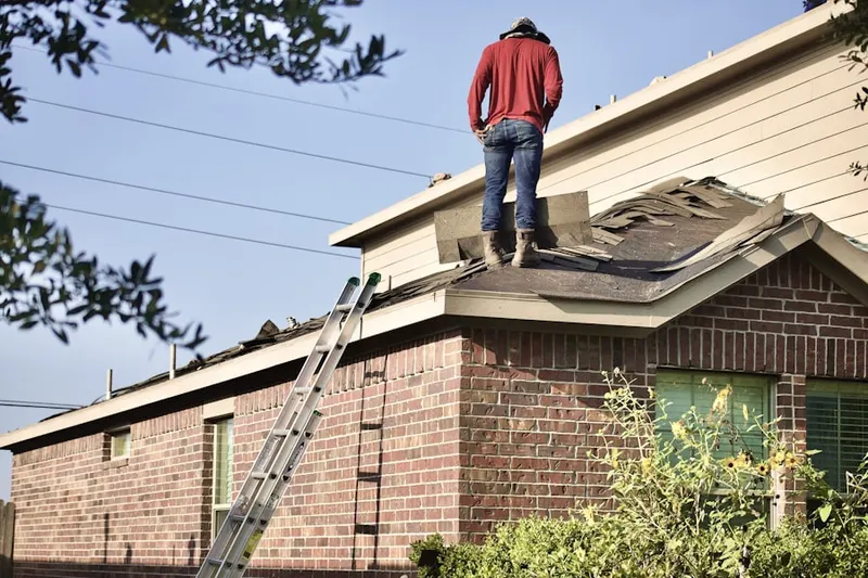 Professional roofer working on a residential roof in Copiague Harbor